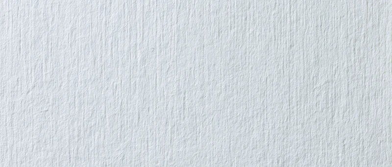 Close-up of white textured paper surface for design or craft use