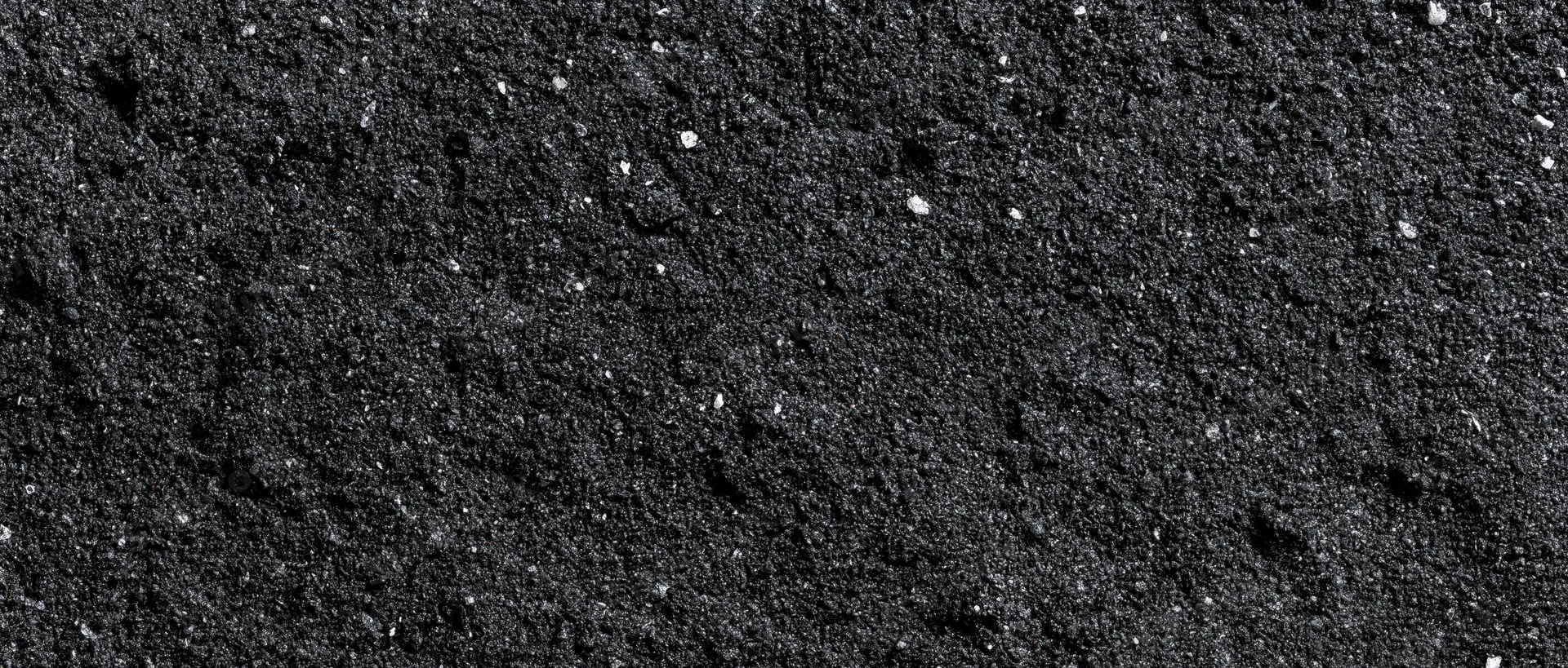 Close-up of dark asphalt surface with fine granular texture