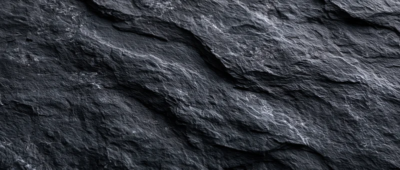 Close-up of dark slate stone surface with natural texture and layered patterns