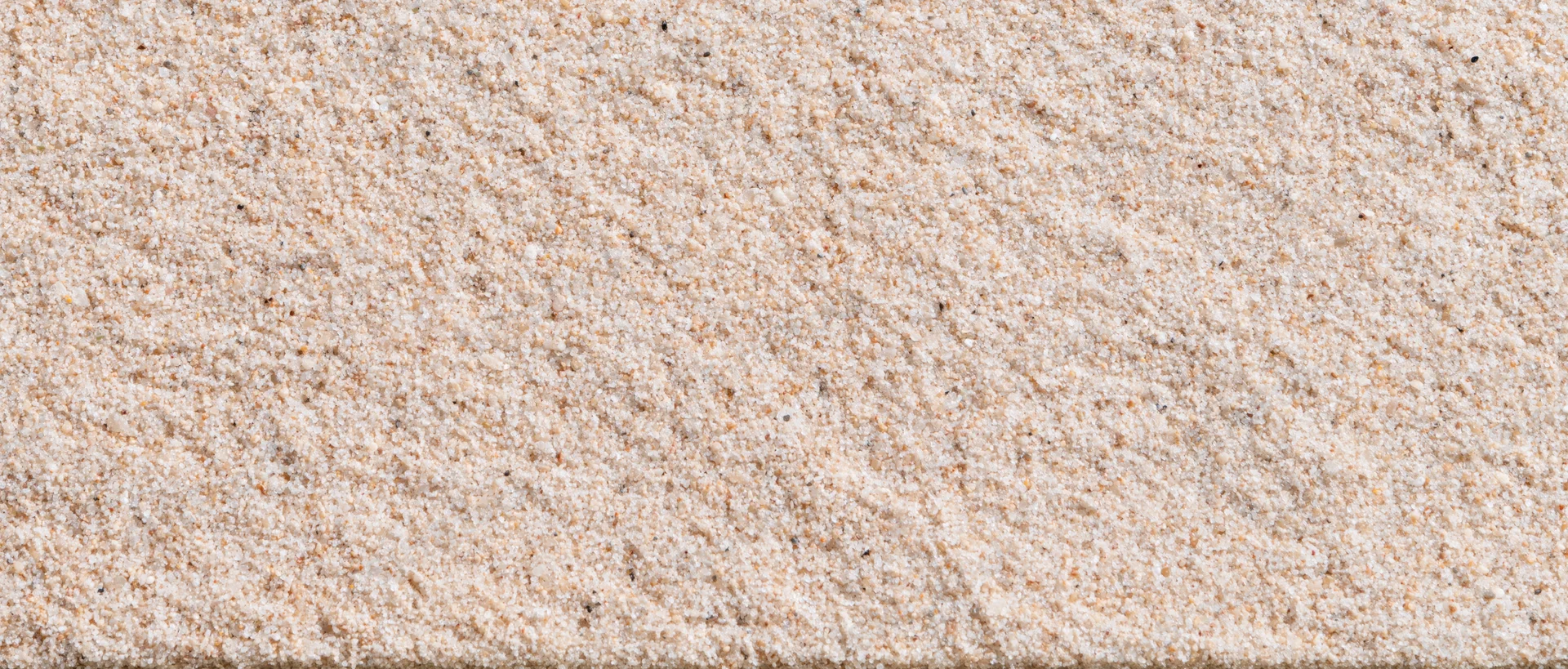 Closeup of dry beach sand texture filling the frame