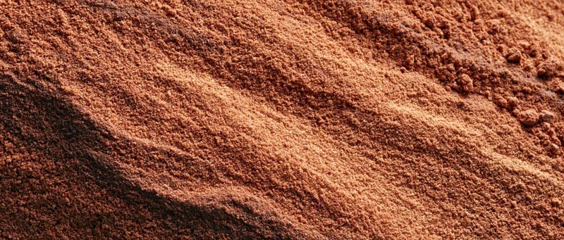 Closeup of coarse dry sand surface with visible texture and layers