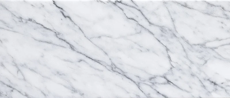 Close-up of white carrara marble surface with gray veining filling the frame