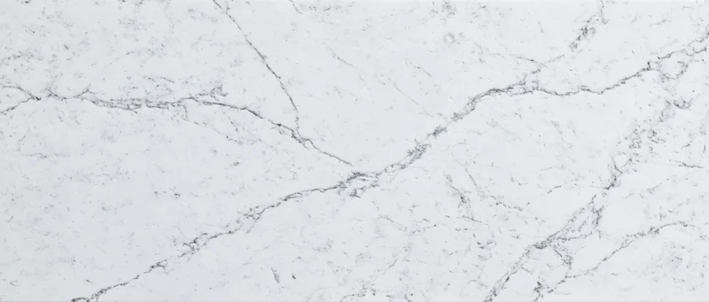 Close-up of white carrara marble surface with natural veining pattern