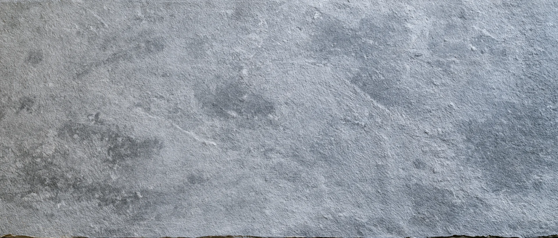 Close-up of a rough gray concrete wall surface filling the frame