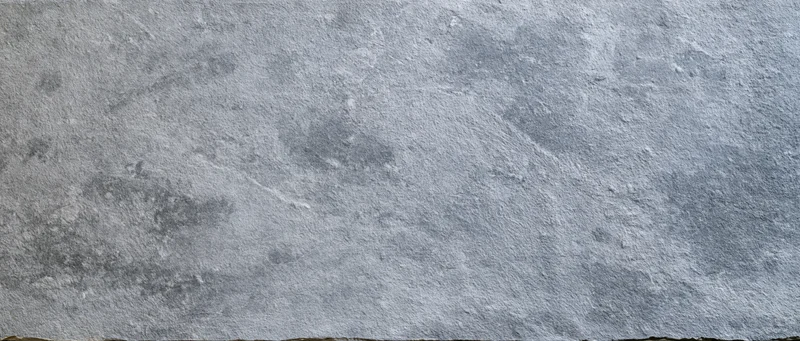 Close-up of a rough gray concrete wall surface filling the frame
