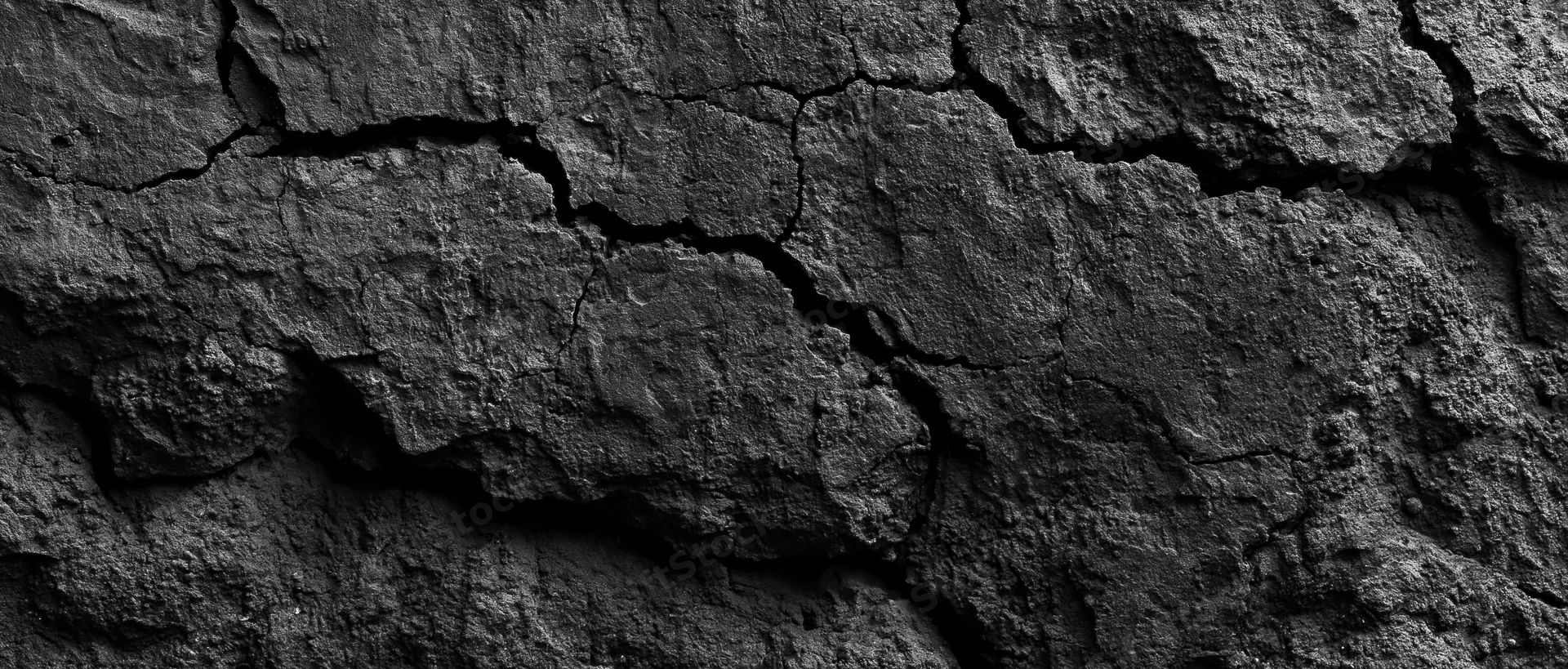 Close-up of cracked dark basalt rock surface showing natural geological texture