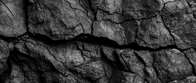 Close-up of cracked basalt rock surface showing natural fractures and rough texture
