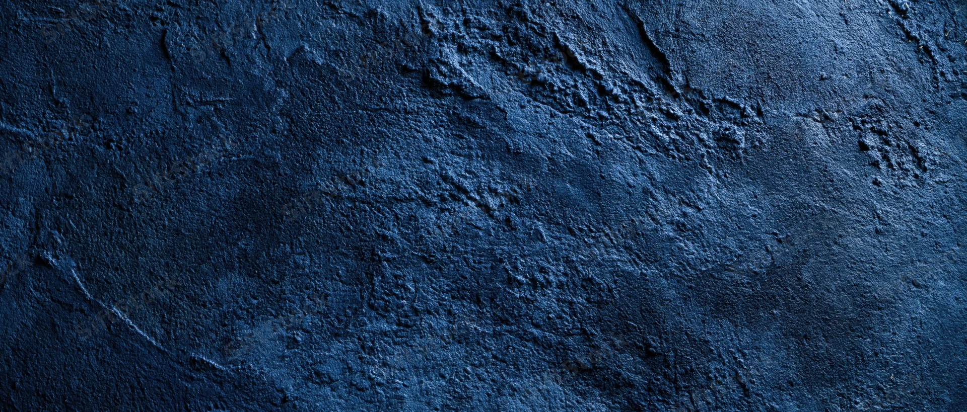 Close-up of a rough blue plastered concrete wall surface