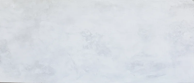Close-up of smooth plastered concrete wall surface with subtle texture and gray-white tone