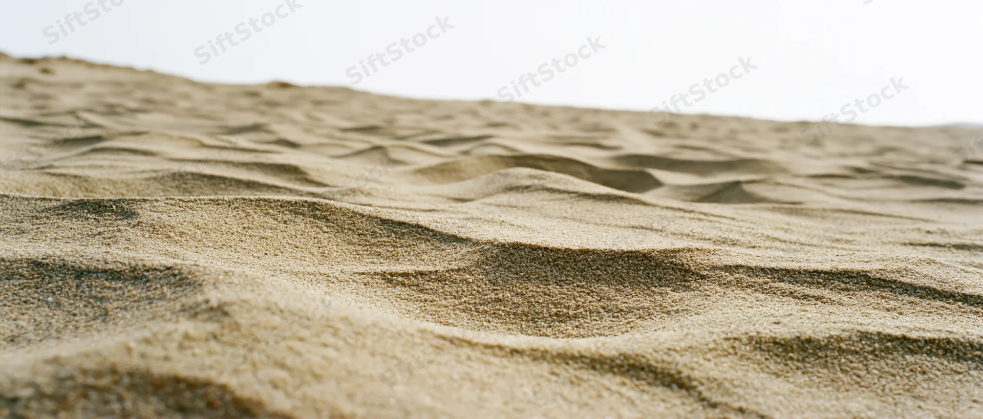 Close-up of rippled dry beach sand at ground level