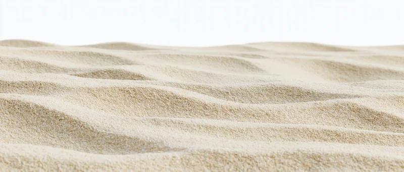 Close-up of rippled dry beach sand at ground level with smooth undulating texture