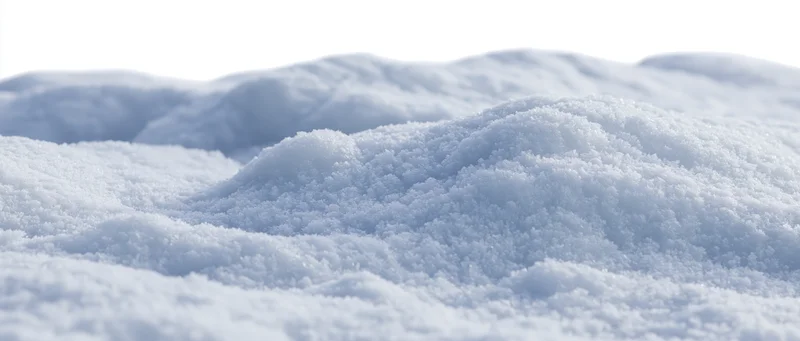 Close-up of fresh snow drifts on the ground in winter
