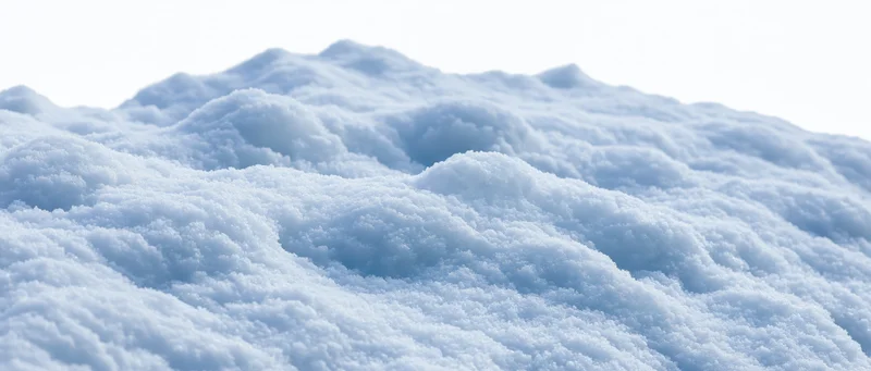 Close-up of fresh snow drifts on a ground-level surface