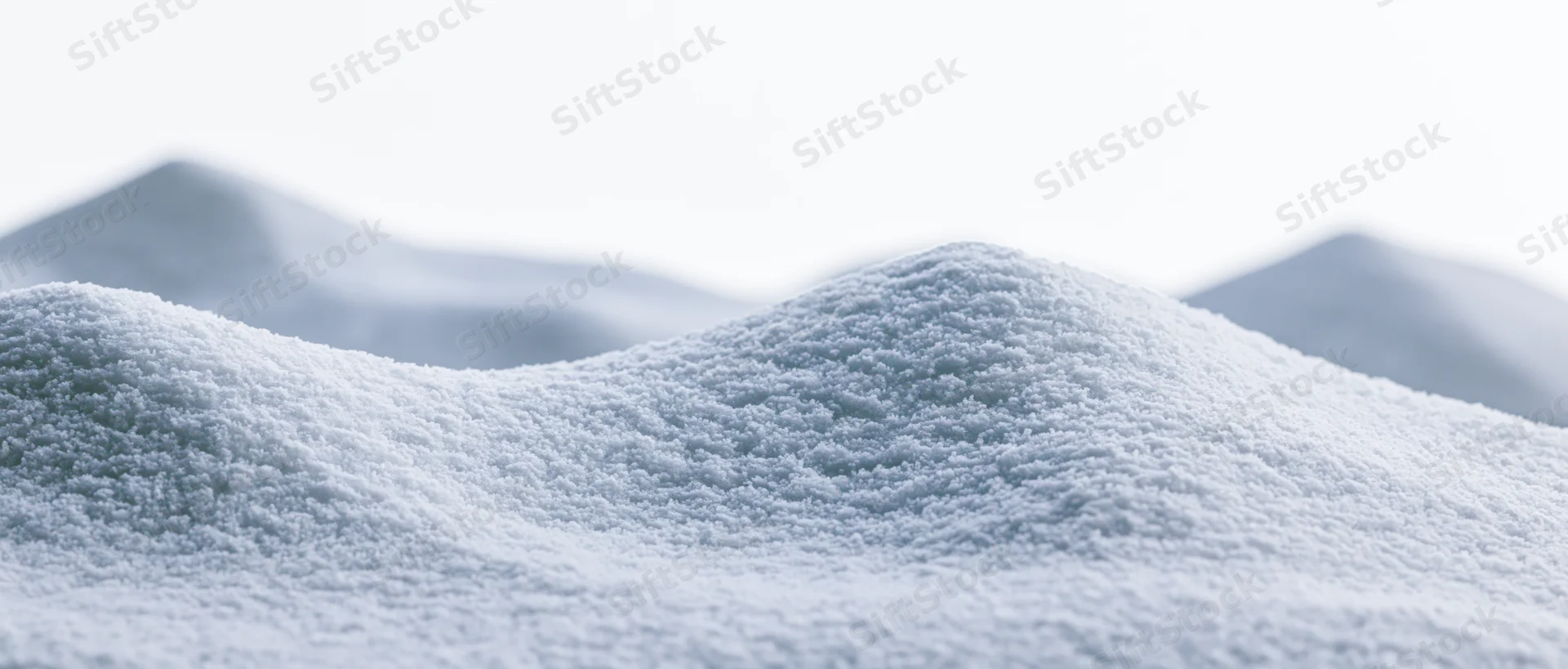 Close-up ground-level view of soft undulating snow drifts in a winter landscape