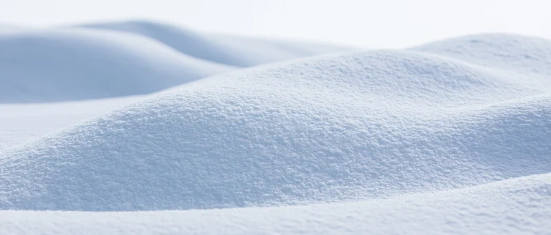 Close-up of soft undulating snow drifts on a winter landscape