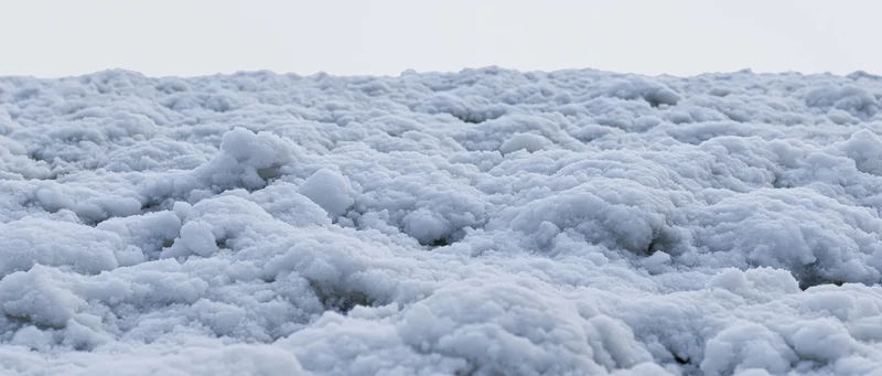 Closeup of freshly disturbed snow surface at ground level