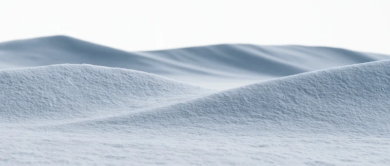 Undulating snow drifts at ground level in a winter landscape