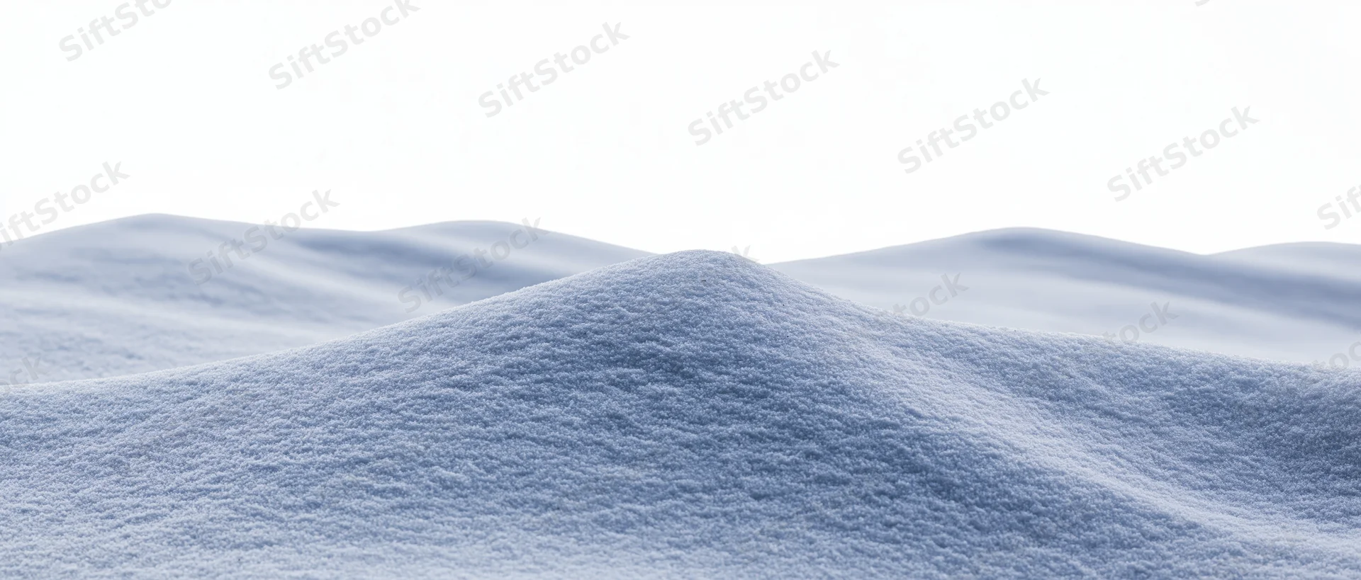 Undulating snow drifts at ground level in a winter landscape