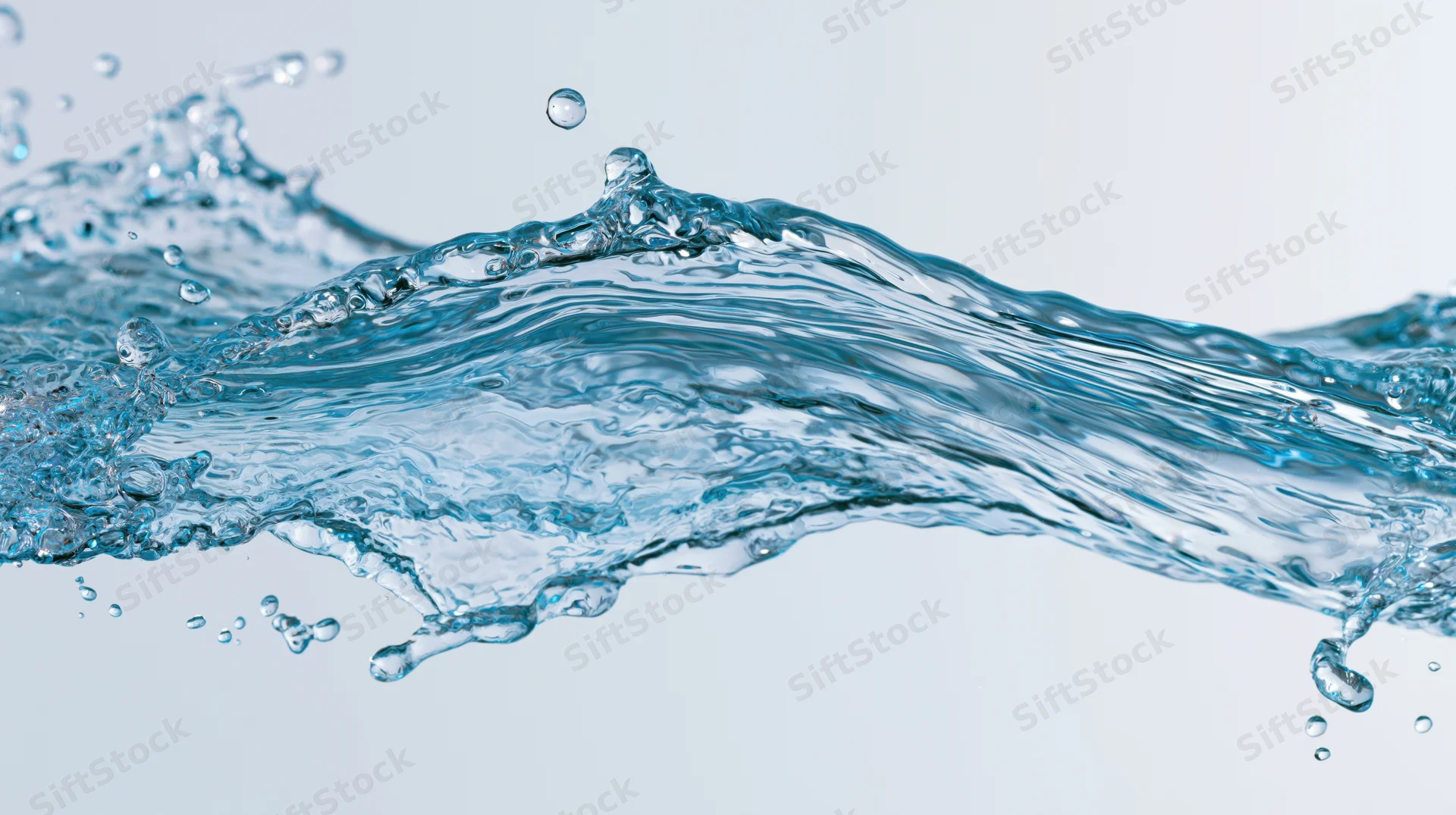 Dynamic water splash mid-motion against a light background