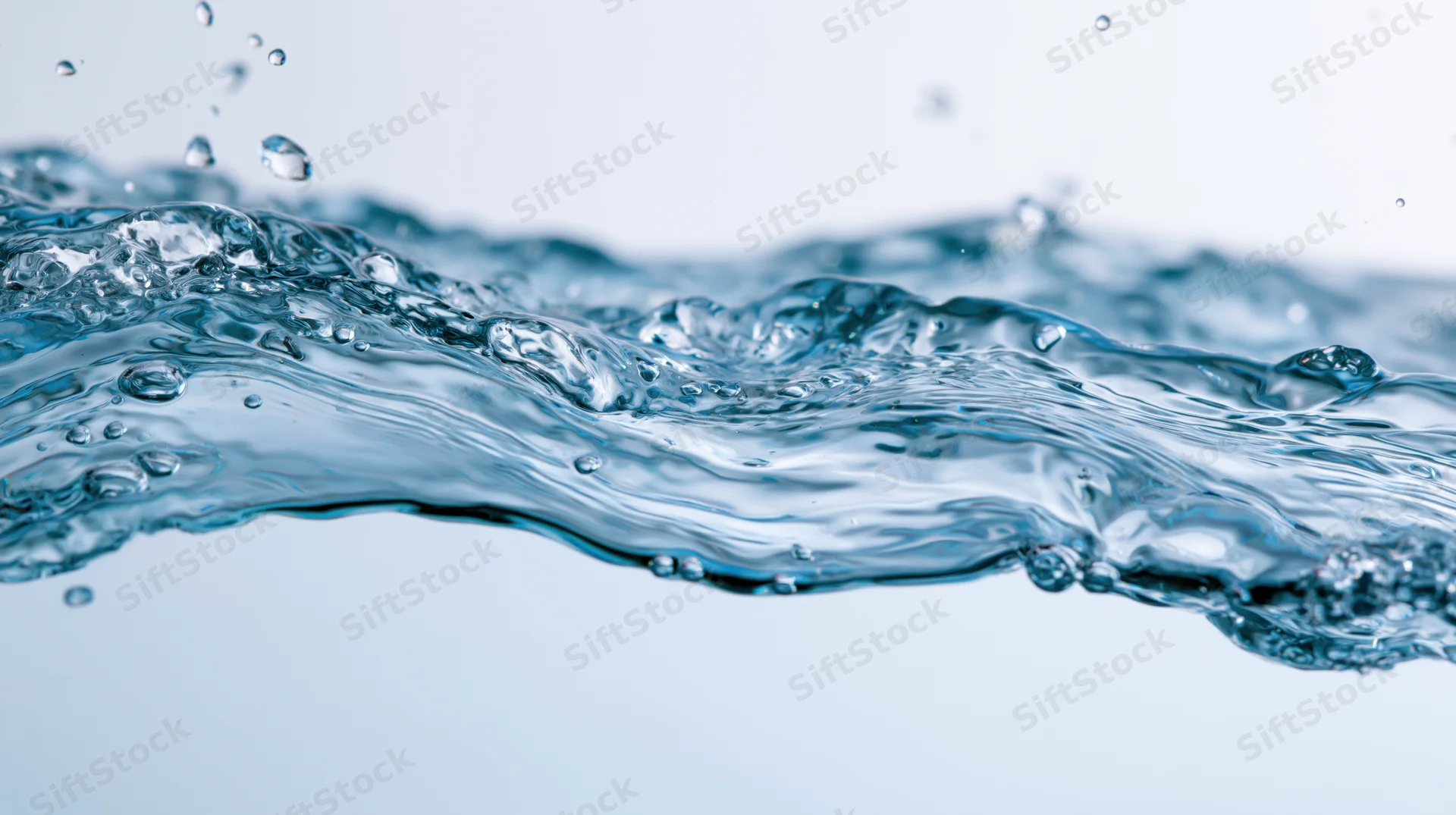 Close-up of dynamic water splash mid-motion with droplets and ripples against white background