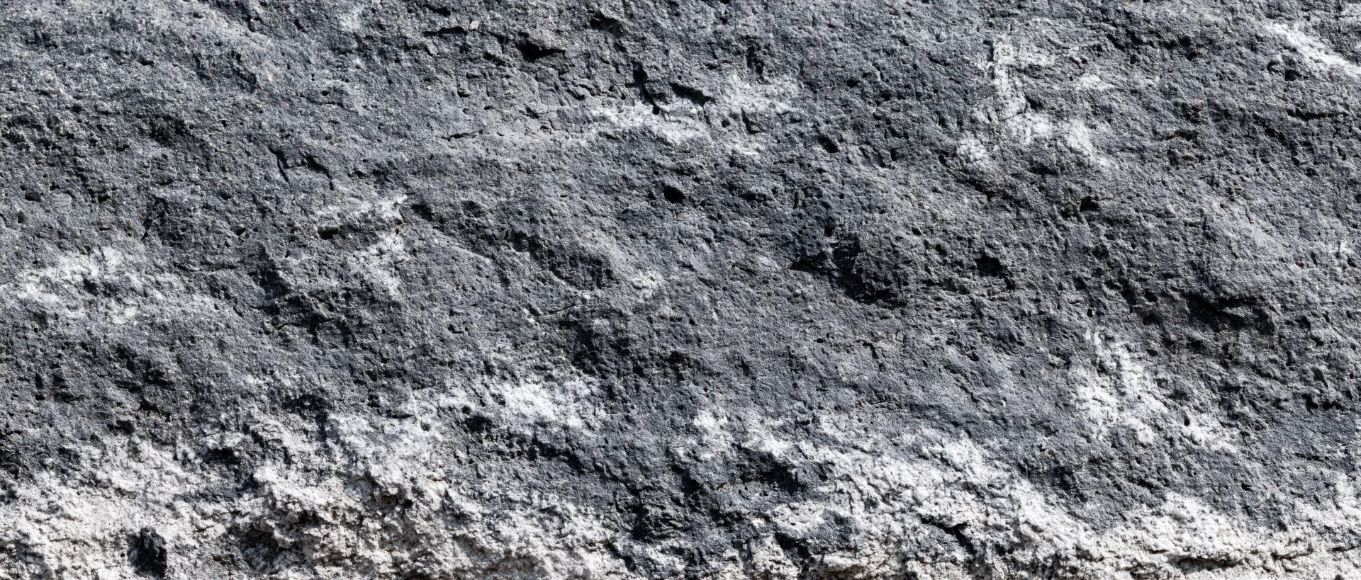 Close-up of rough granite rock surface showing natural texture and mineral grain patterns