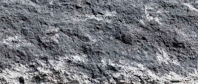 Close-up of rough granite rock surface showing natural texture and mineral grain patterns