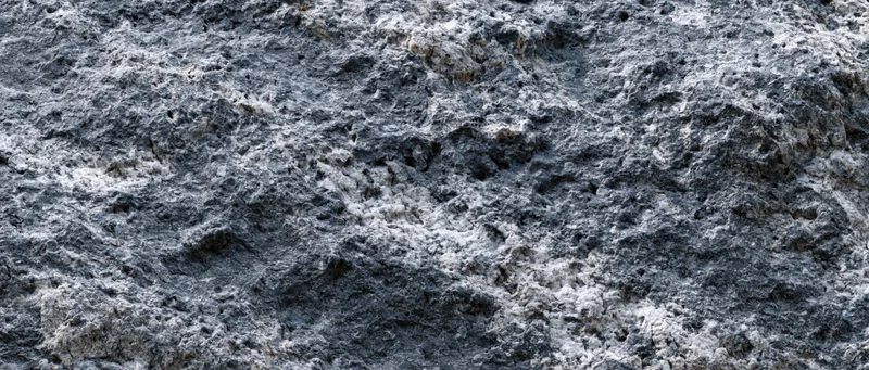 Close-up of rough granite rock surface showing natural texture and mineral grain pattern