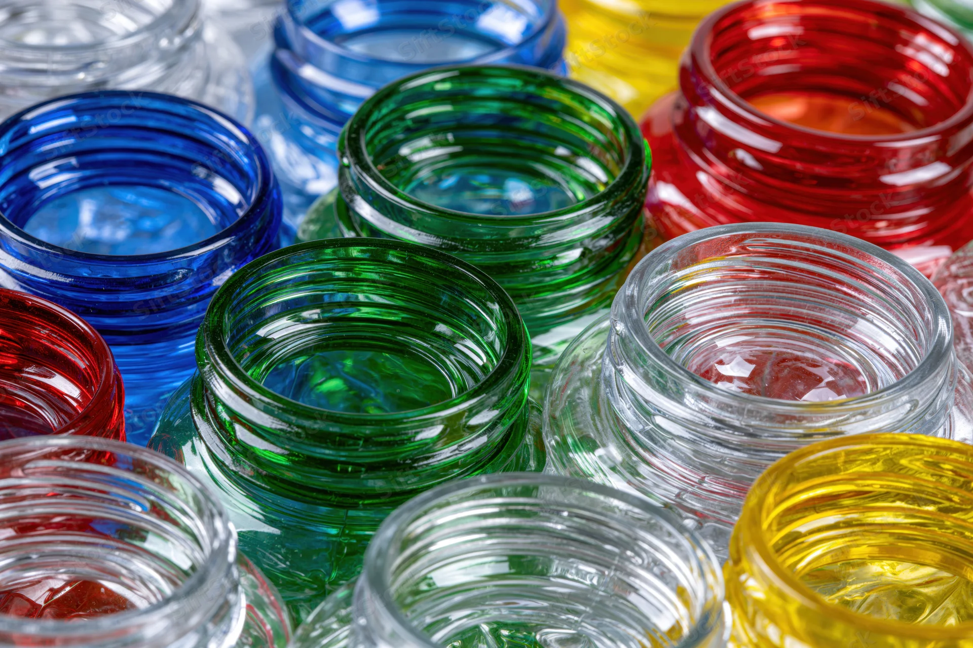 Scattered empty plastic bottles and caps in vibrant colors, close-up view