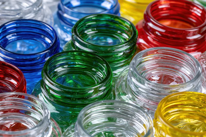 Scattered empty plastic bottles and caps in vibrant colors, close-up view