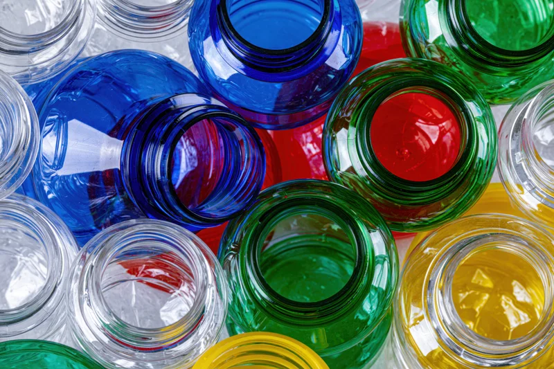 Scattered empty plastic bottles and caps in vibrant colors viewed from above