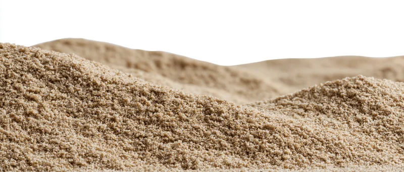 Close-up of small dry sand mounds with gently rolling surface against white background