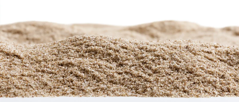 Close-up of small dry sand mounds with gently rolling surface on white background