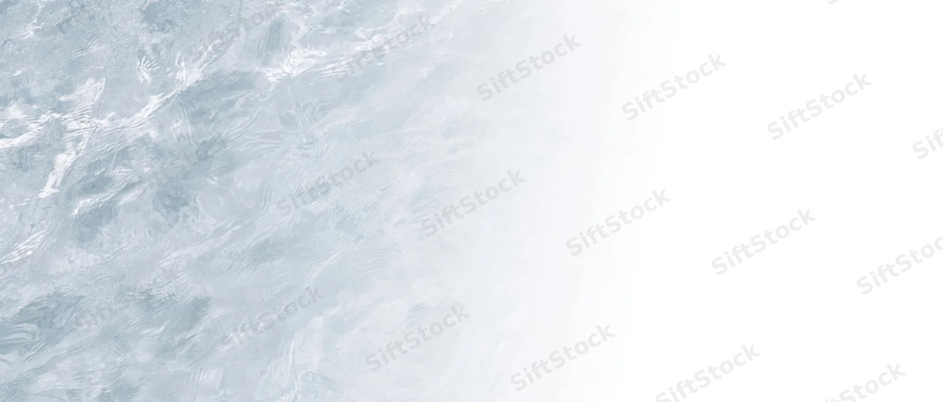 Closeup overhead view of clear shallow water surface with ripples and light reflections