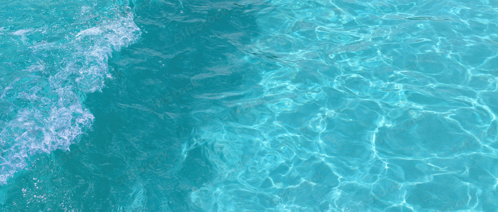 Overhead closeup of clear turquoise pool water surface with ripples and light reflections