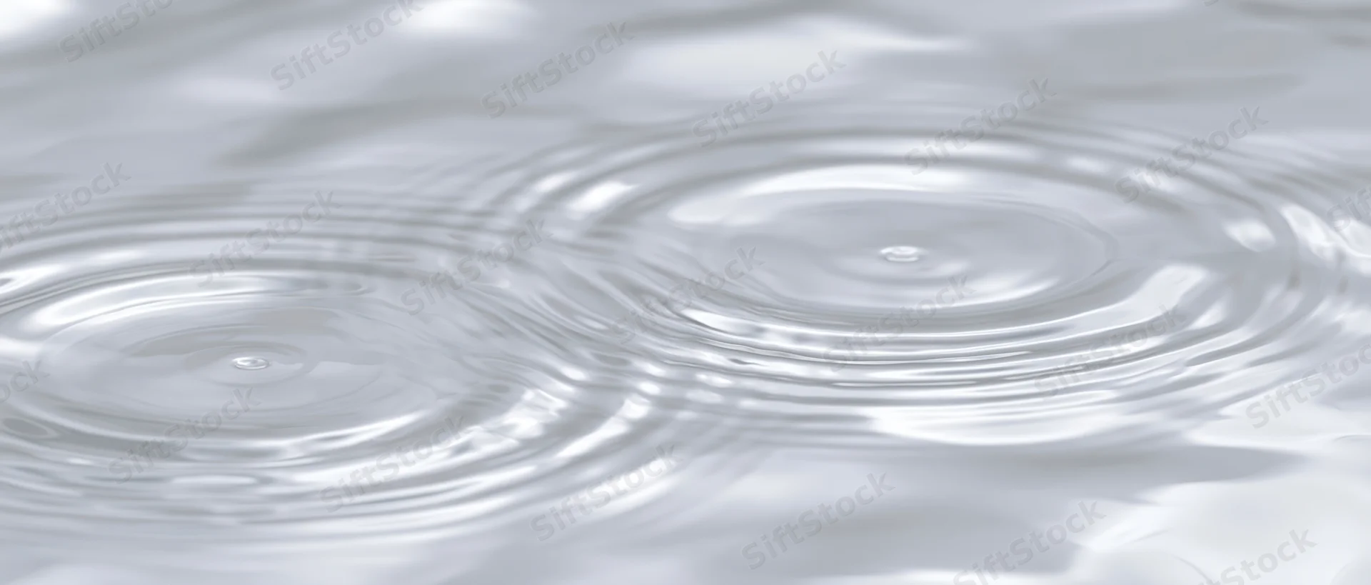 Close-up of concentric ripples spreading across a calm water surface
