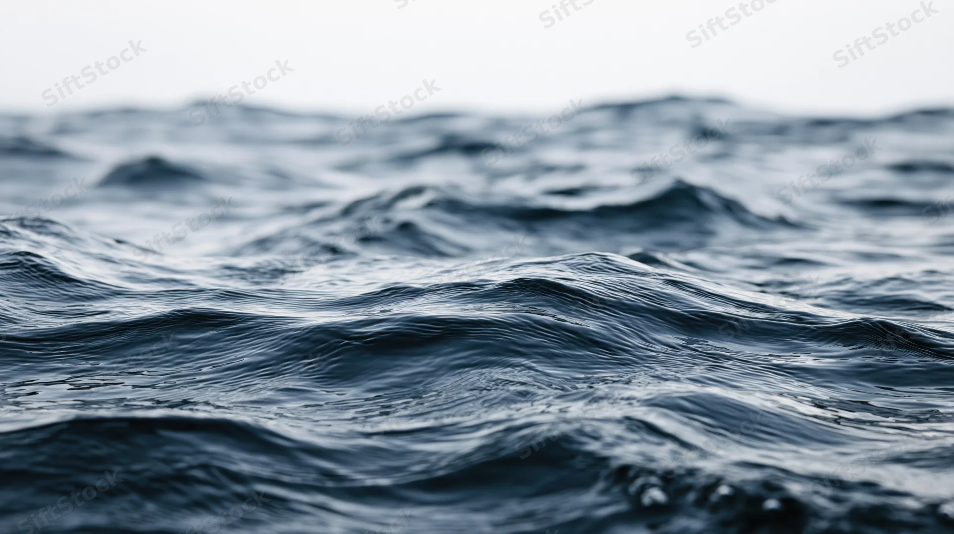 Close-up of dark blue ocean waves undulating at surface level