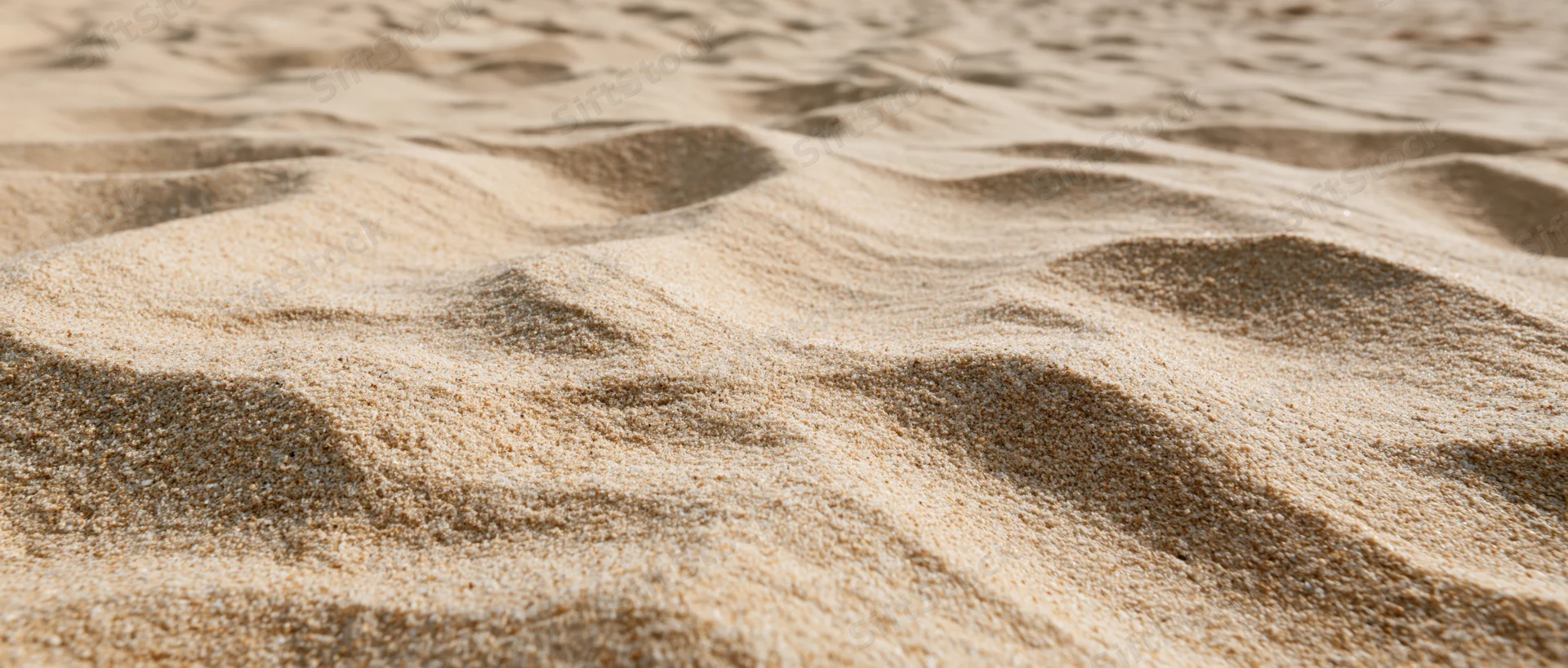 Closeup of undulating dry beach sand texture filling the frame