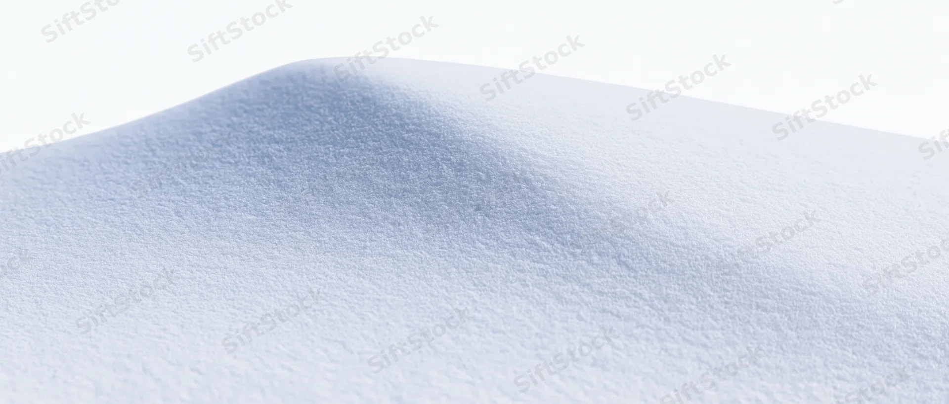 Close-up of smooth fresh snow surface forming a gentle ridge