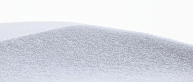 Close-up of smooth fresh snow surface forming a gentle ridge outdoors