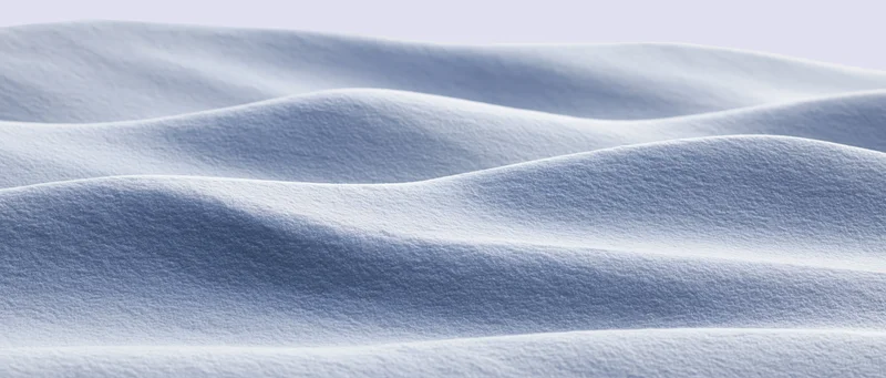 Smooth undulating snow surface in a wide panoramic winter landscape