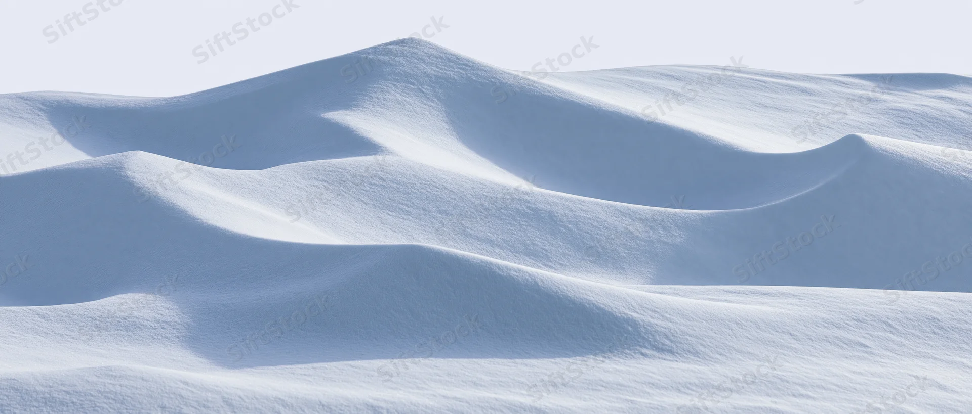 Smooth undulating snow surface under bright sky in winter landscape
