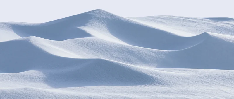Smooth undulating snow surface under bright sky in winter landscape