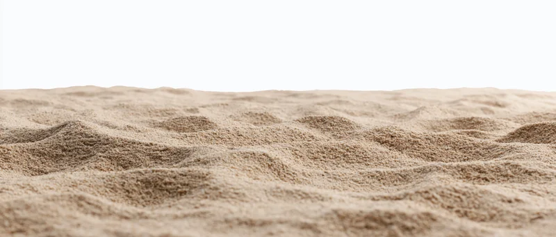 Close-up of dry beach sand surface with ripples and texture against white background