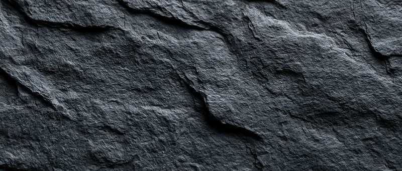 Close-up of dark slate stone wall surface filling the frame