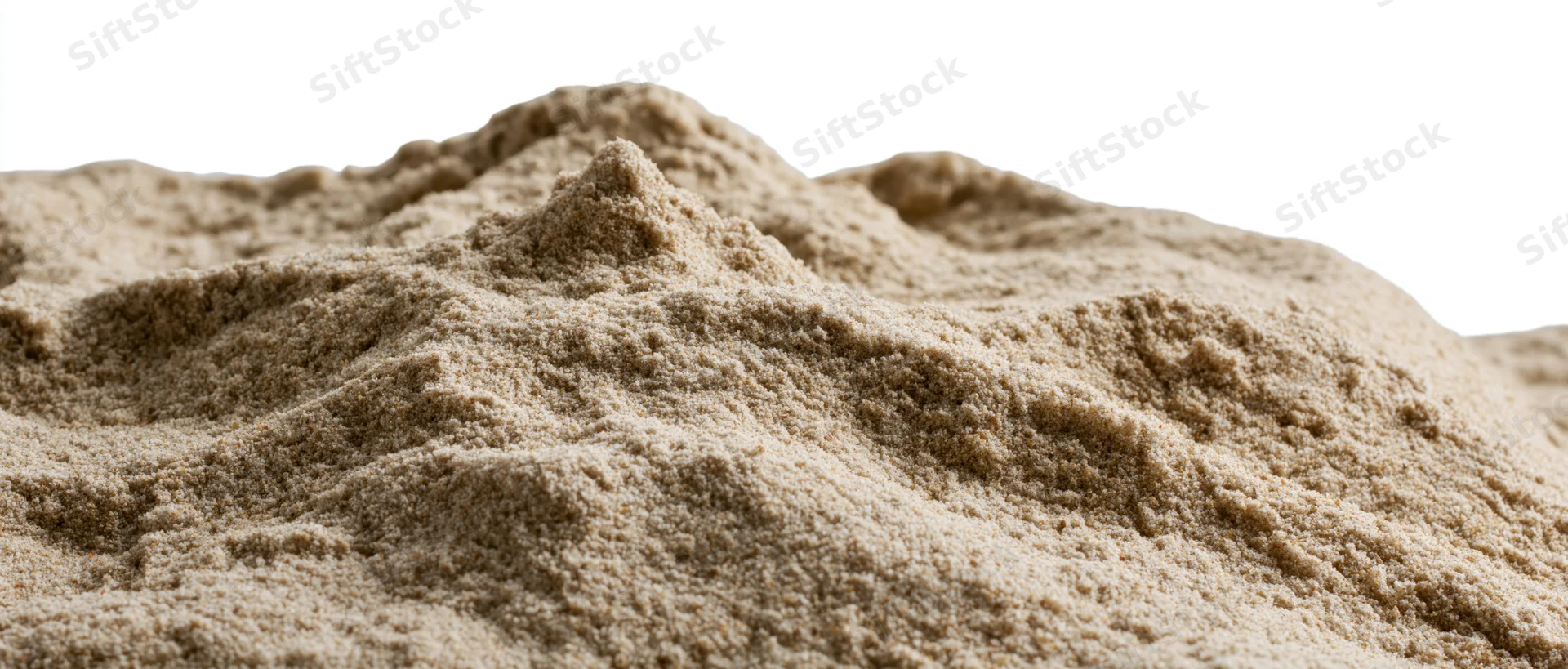 Close-up of a dry sand mound with uneven ridges and textured surface isolated on white