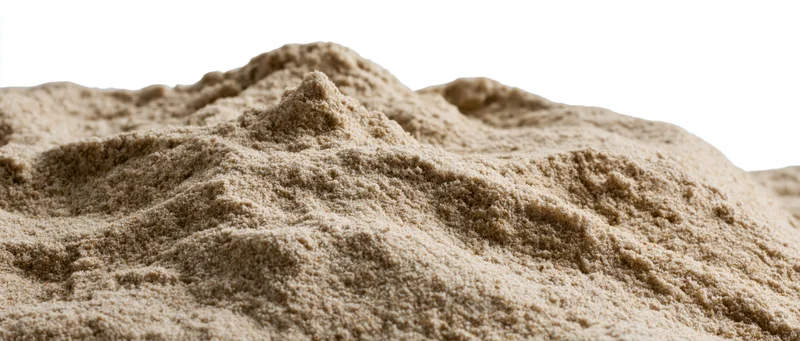 Close-up of a dry sand mound with uneven ridges and textured surface isolated on white