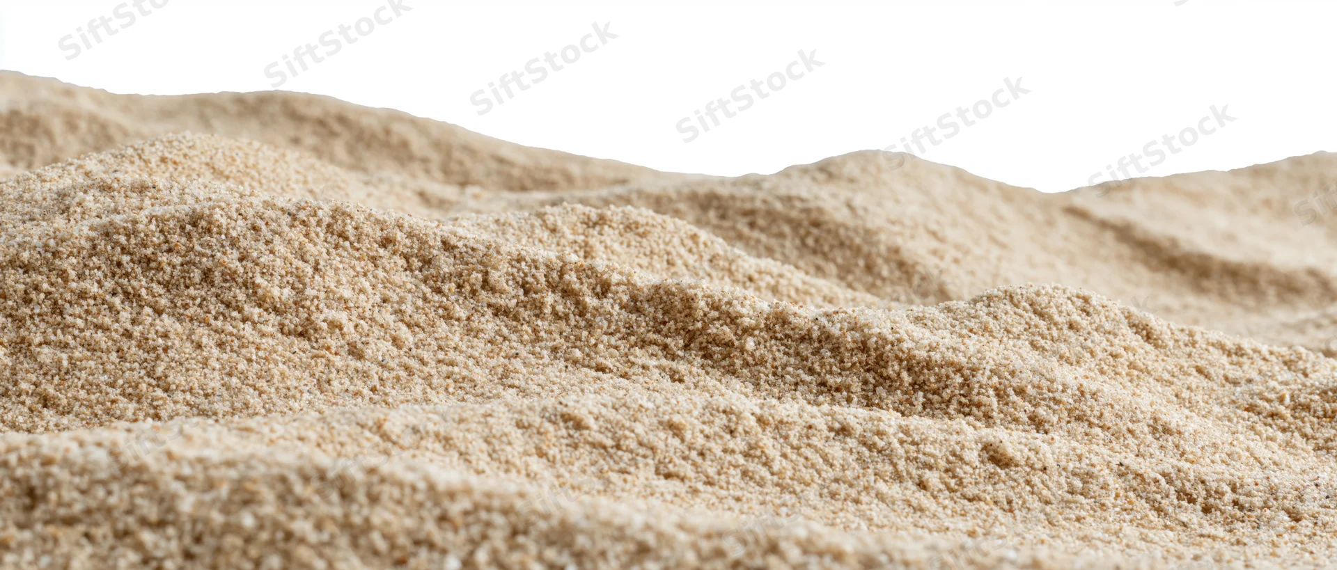 Close-up of rippled dry beach sand forming small dunes against white background