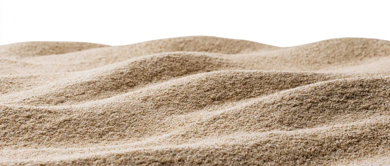Rippled dry beach sand forming small dunes against white background