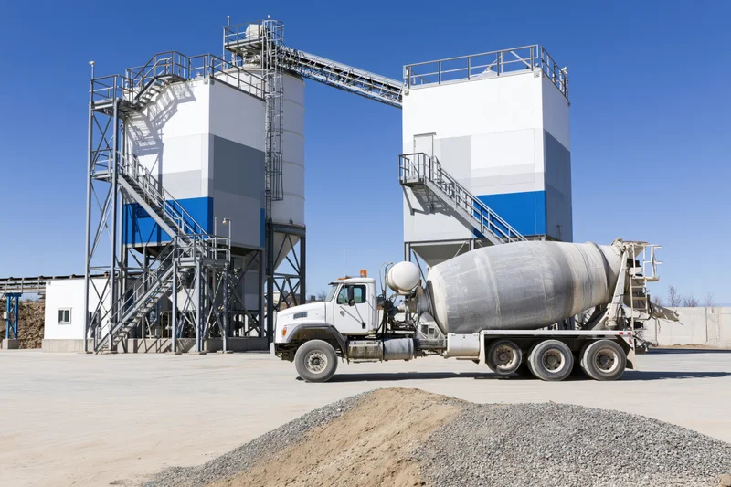 Concrete mixer truck parked at cement batching plant facility