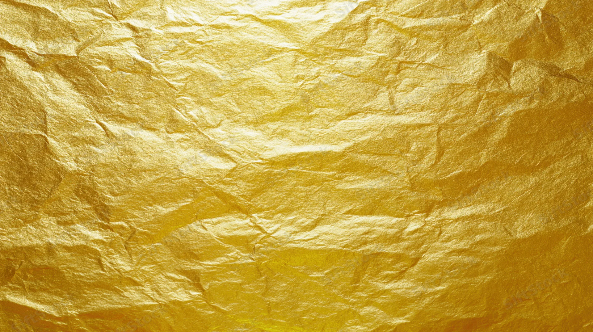 Crumpled gold foil sheet filling the frame as a textured background